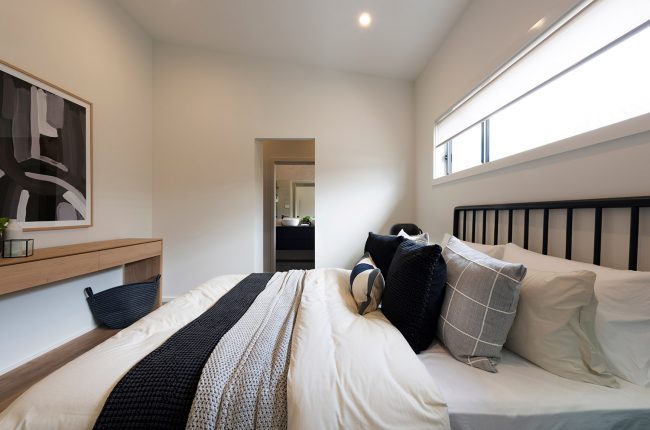 Southport 217 bedroom with piles of blankets and pillows