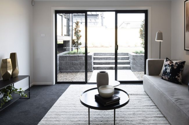 Split level living room leading to backyard in San Tropez home design