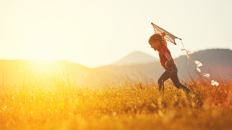 child playing with kite at avery green