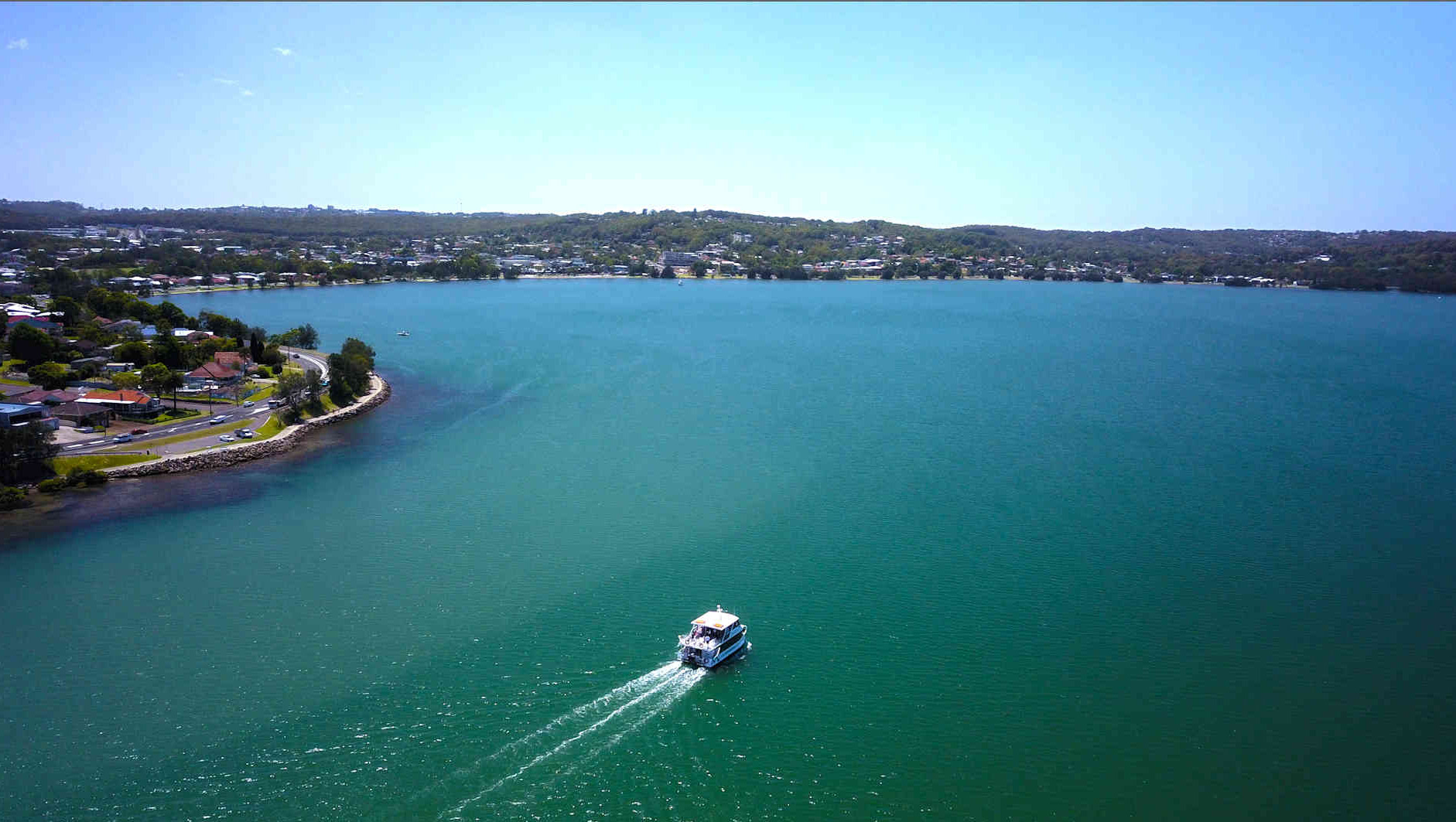 boat cruising along the water near munibung hill