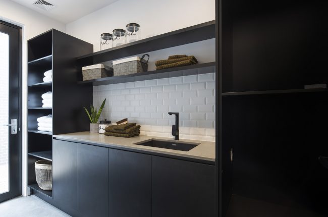 Cayman 287 laundry with white brick splashback