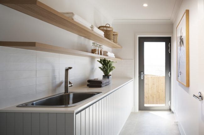 Bondi 249 laundry with white panelled cupboards