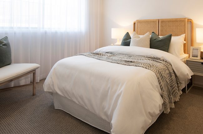 Bondi 249 display home with white curtains and cane furniture