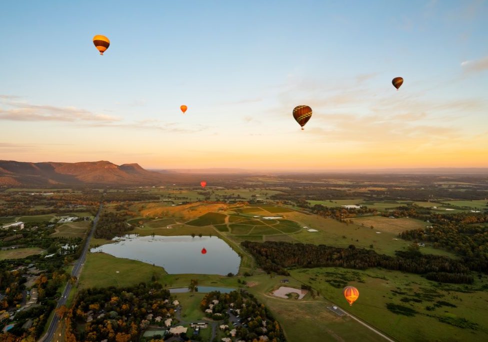 Hot air Balloons in Pokolbin wine region over wineries and vineyards, Aerial image, Hunter Valley, NSW, Australia