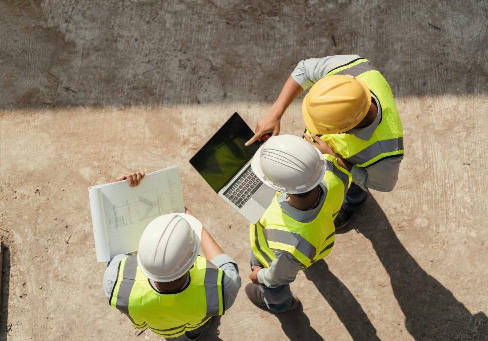 Team engineer building inspection use computer laptop and blueprint working at construction site. Teamwork discussing at workplace.. Team engineer building inspection use computer laptop and blueprint working at construction site. Teamwork discussing at workplace..