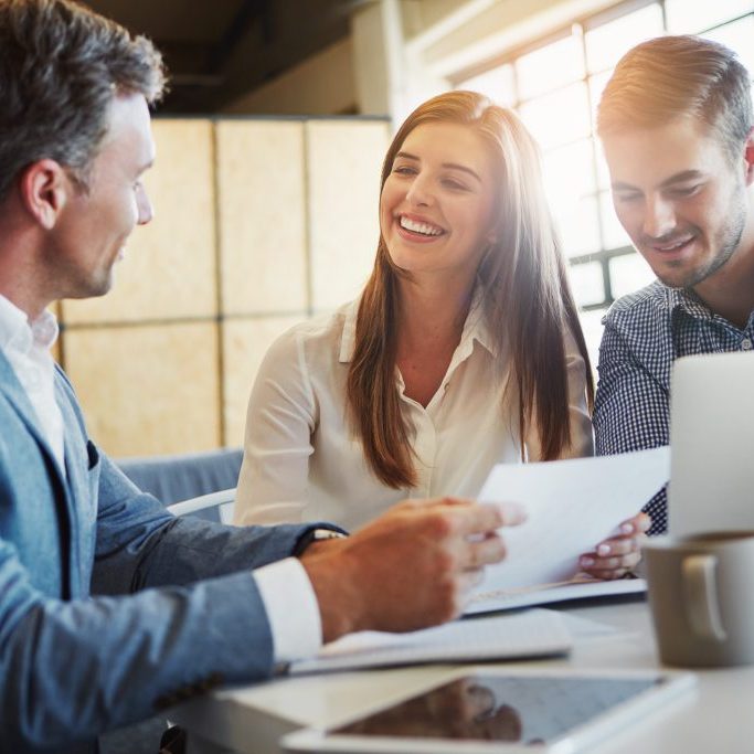 Cropped shot of three businesspeople working in the office